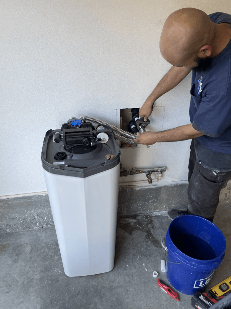 Technician installing the perfect water solution for a home water softener system for improved water quality.